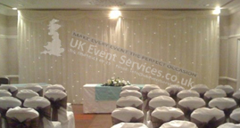 Ivory venue drape with white chair covers
